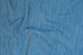 Crumpled denim seamless fabric texture. Dark blue color