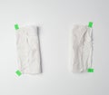 Crumpled dirty white piece of paper towel glued with green paper velcro