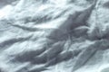 Crumpled fabric with white folds as an abstract textile background. Royalty Free Stock Photo