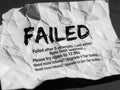 Crumpled failed paper with error message isolated on white background Royalty Free Stock Photo