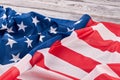 Crumpled flag of USA on wooden background. Royalty Free Stock Photo