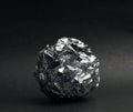 Crumpled foil ball on a black Royalty Free Stock Photo