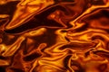 Crumpled foil with light playing on its surface. Visual effect. Abstract orange-black background Royalty Free Stock Photo