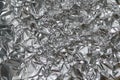 Crumpled foil texture background. Metal paper shit. Silver aluminum surface. Gift wrapping shiny paper. Glitter effect. Royalty Free Stock Photo