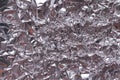 Crumpled foil texture background. Metal paper shit. Silver aluminum surface. Gift wrapping shiny paper. Glitter effect. Royalty Free Stock Photo