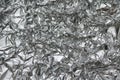 Crumpled foil texture background. Metal paper shit. Silver aluminum surface. Gift wrapping shiny paper. Glitter effect. Royalty Free Stock Photo