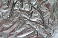 Crumpled foil texture background. Metal paper shit. Silver aluminum surface. Gift wrapping shiny paper. Glitter effect. Royalty Free Stock Photo