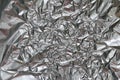 Crumpled foil texture background. Metal paper shit. Silver aluminum surface. Gift wrapping shiny paper. Glitter effect. Royalty Free Stock Photo