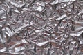 Crumpled foil texture background. Metal paper shit. Silver aluminum surface. Gift wrapping shiny paper. Glitter effect. Royalty Free Stock Photo