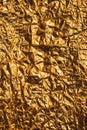 Crumpled gold colored aluminum tin foil texture as background Royalty Free Stock Photo