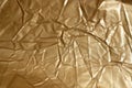 Crumpled gold-colored paper. Royalty Free Stock Photo