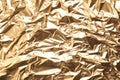 Crumpled gold foil as background, top view