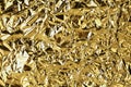 Crumpled golden foil shining texture background, bright shiny gold luxury design, metallic glitter surface Royalty Free Stock Photo