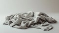 A crumpled gray blanket resting on a smooth surface Royalty Free Stock Photo