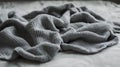 A crumpled gray blanket resting on a smooth surface Royalty Free Stock Photo