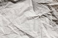 Crumpled gray craft paper texture background. Package wrapping. Old wrapping paper. Baking parchment. Letter template.