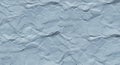Crumpled gray paper with a rough texture and uneven surface features. The folds and Royalty Free Stock Photo