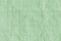 Crumpled green grid paper textured background