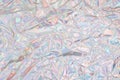 Crumpled holographic wrapping paper with shiny effect. Close up, top view