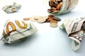 Crumpled hundred dollar bills and spilled coin jar money Royalty Free Stock Photo