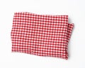 Crumpled kitchen red-white towel in on a white background Royalty Free Stock Photo