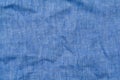 Crumpled light blue linen fabric background, close up