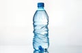 Crumpled light blue plastic water bottle isolated on white background. Plastic bottle full of water. Shows problem of plastic Royalty Free Stock Photo
