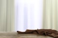 Crumpled napkin on wooden table in room against blurred background Royalty Free Stock Photo