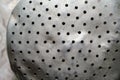 Crumpled old aluminum colander with holes. Close-up.