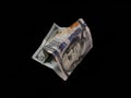 Crumpled one hundred american dollars on a black background. Bad American money, close-up. Concept: devaluation, falling currency Royalty Free Stock Photo