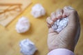 Crumpled paper ball in hand on office table Royalty Free Stock Photo