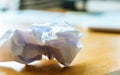 Crumpled paper ball on office desk Royalty Free Stock Photo