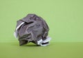 crumpled paper ball over green Royalty Free Stock Photo