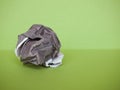 crumpled paper ball over green Royalty Free Stock Photo