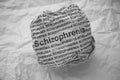 Crumpled paper ball with words Schizophrenia on crumpled white paper background Royalty Free Stock Photo