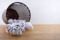Crumpled paper balls all around a black recycle bin Royalty Free Stock Photo