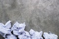 Crumpled paper balls on a gray concrete surface