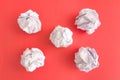 Crumpled paper balls on red background