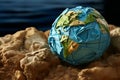 Crumpled paper Earth model symbolizes environmental degradation