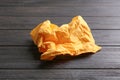 Crumpled paper napkin on wooden background. Royalty Free Stock Photo