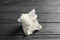 Crumpled paper napkin on wooden background. Royalty Free Stock Photo