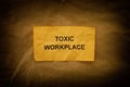 A crumpled paper note with the words Toxic Workplace on it Royalty Free Stock Photo
