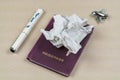 Crumpled paper on a passport with pen Royalty Free Stock Photo