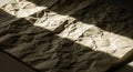 Crumpled paper with a rough texture and uneven surfaces placed in partial shadow. Royalty Free Stock Photo