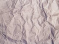 Crumpled paper texture with a light beige tone, showcasing multiple creases and folds.