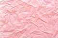 Crumpled paper texture pink trendy abstract background.