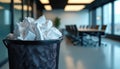 Crumpled papers fill rubbish bin in modern office meeting room. Represents failed business ideas, need for teamwork, Royalty Free Stock Photo