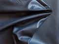 Crumpled piece of black cattle leather