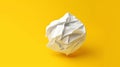 crumpled piece of paper on yellow background