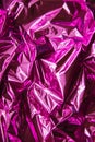 Crumpled pink foil. The background shimmers with rainbow colors Royalty Free Stock Photo